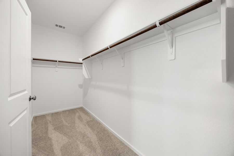The generously sized walk-in closet provides exceptional storage space with room for clothing, shoes, seasonal décor, and more.