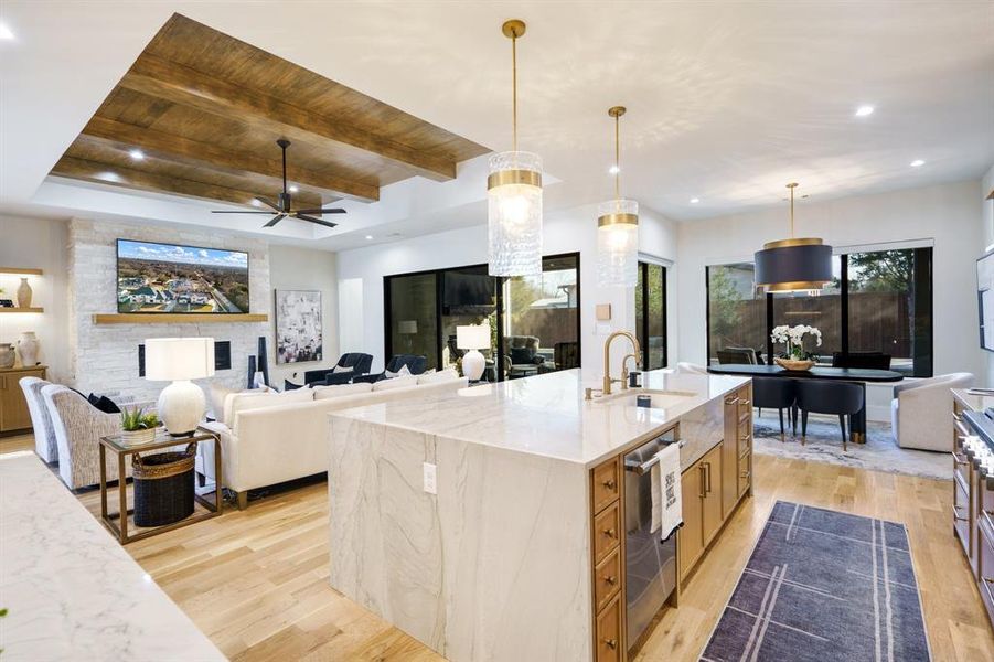 Kitchen featuring oversized pendant lighting, quartzite sink bib, and gorgeous view of the patio/pool