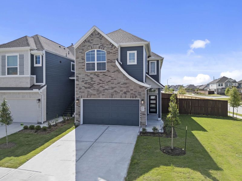 Front exterior of a new home in Meridiana, Manvel, TX, highlighting curb appeal (Image 19).