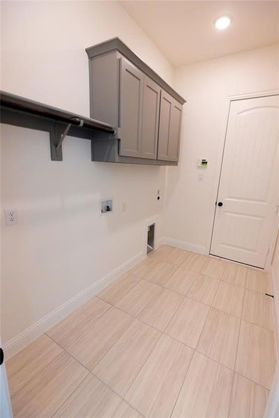 Laundry room featuring cabinets, washer hookup, and electric dryer hookup