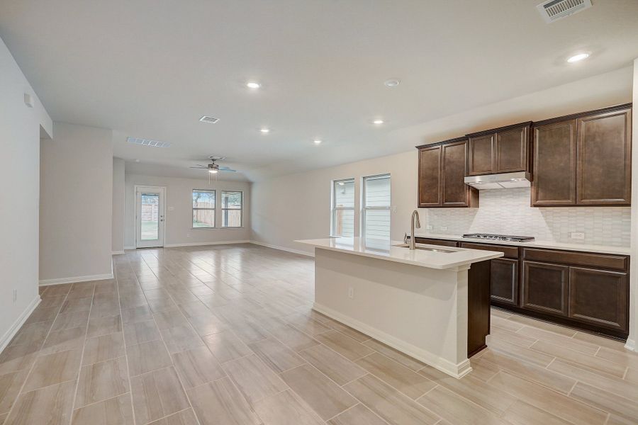 Kitchen, dining room, and living room in the Oleander floorplan at a Meritage Homes community.