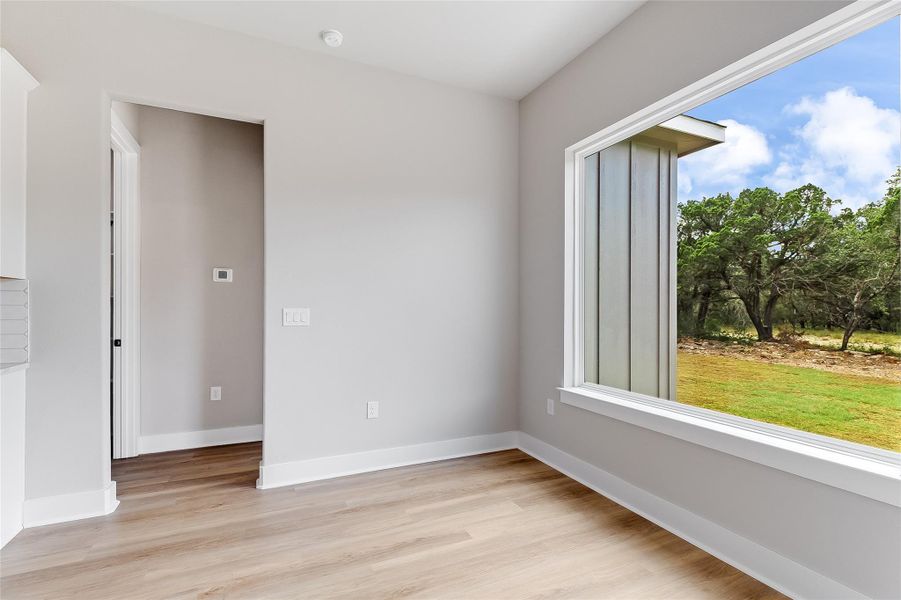 Dining area with oversized window overlooking back yard Dining area with oversized window overlooking back yard