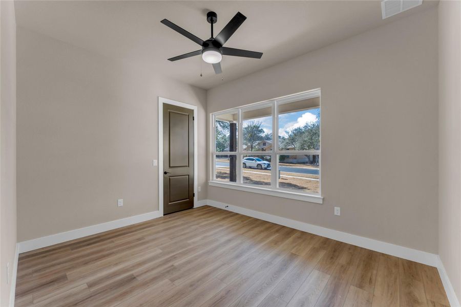 Unfurnished room with light wood-style flooring and a ceiling fan