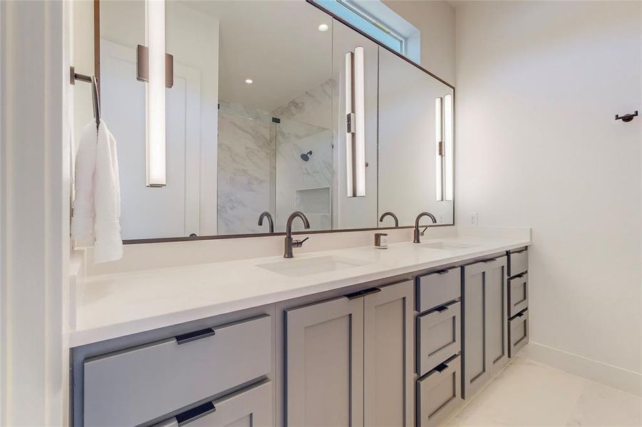 Bathroom with tile patterned floors and double vanity