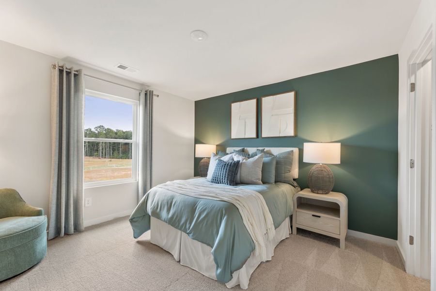 A bedroom with a large window. A bedroom with a large window.