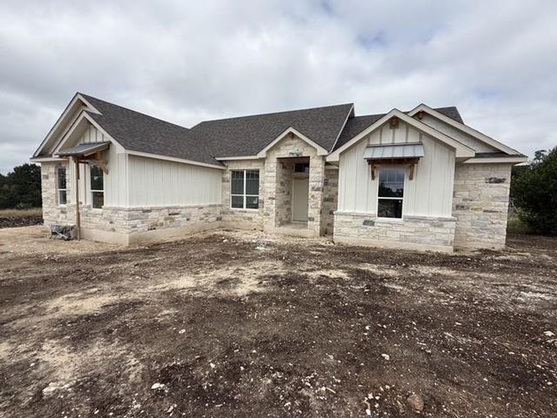 A newly constructed residence combines board and batten siding with stone accents for captivating curb appeal.