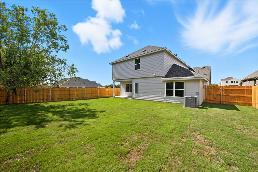 Back of property with a fenced backyard and a shingled roof Back of property with a fenced backyard and a shingled roof