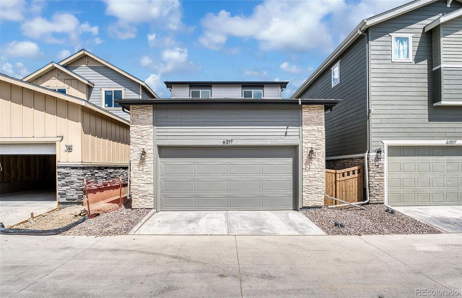 Front exterior of a new home in Painted Prairie, Aurora, CO, highlighting curb appeal (Image 2).