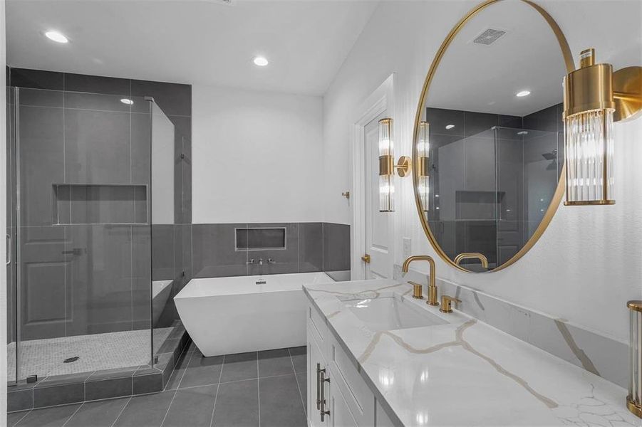 Full bathroom featuring vanity, a freestanding bath, a stall shower, recessed lighting, and tile patterned flooring Full bathroom featuring vanity, a freestanding bath, a stall shower, recessed lighting, and tile patterned flooring