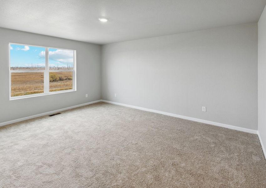 The master bedroom is spacious with a large window. The master bedroom is spacious with a large window.