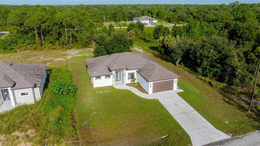 Front exterior of a new home in , Lehigh Acres, FL, highlighting curb appeal (Image 29).