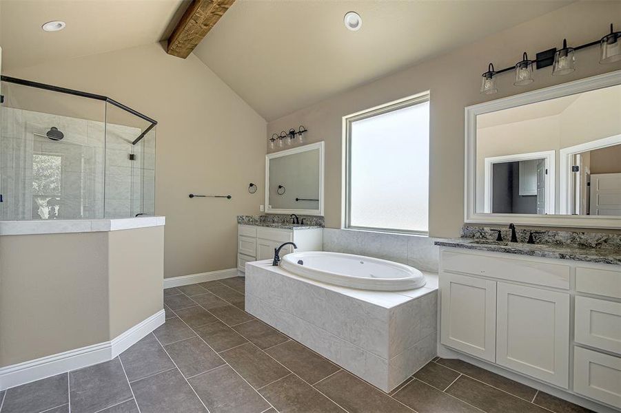 Bathroom featuring independent shower and bath, tile patterned flooring, lofted ceiling with beams, and vanity