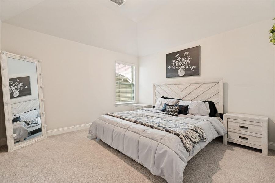 Carpeted room featuring a window with blinds, white baseboards, and a ceiling vent
