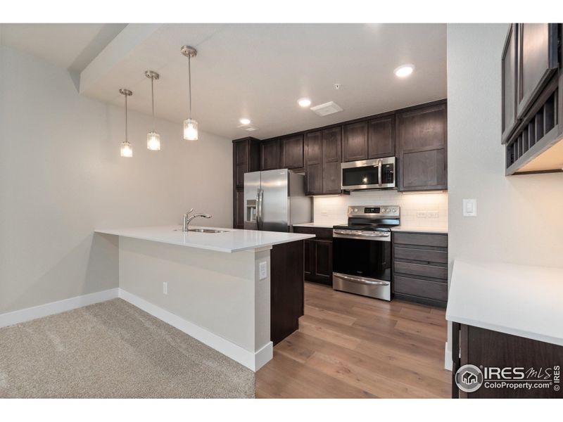 Bright, open kitchen. Photos of actual unit.