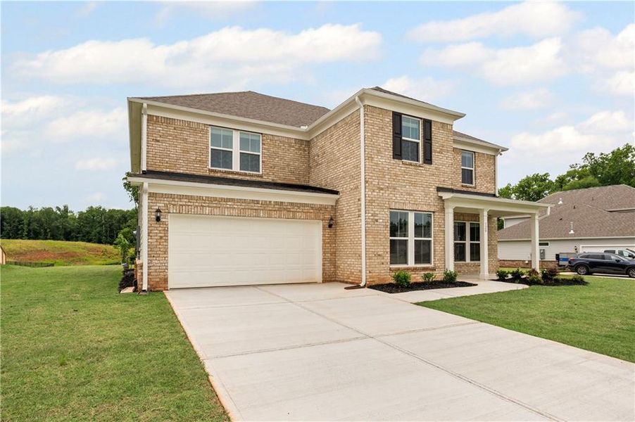 Front exterior of a new home in Anderson Point Estates, McDonough, GA, highlighting curb appeal (Image 2).