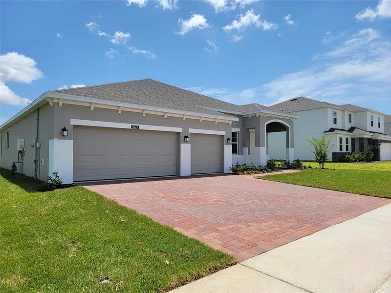 Front exterior of a new home in Bargrove Estates, Mount Dora, FL, highlighting curb appeal (Image 2). Front exterior of a new home in Bargrove Estates, Mount Dora, FL, highlighting curb appeal (Image 2).