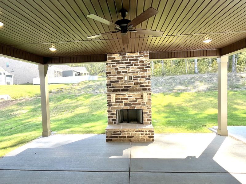 Love this deep back porch and fireplace. Did I mention it backs up to the woods?