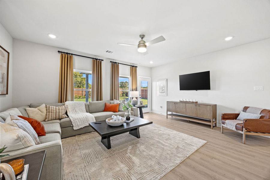 A living room with a tv and couches. A living room with a tv and couches.