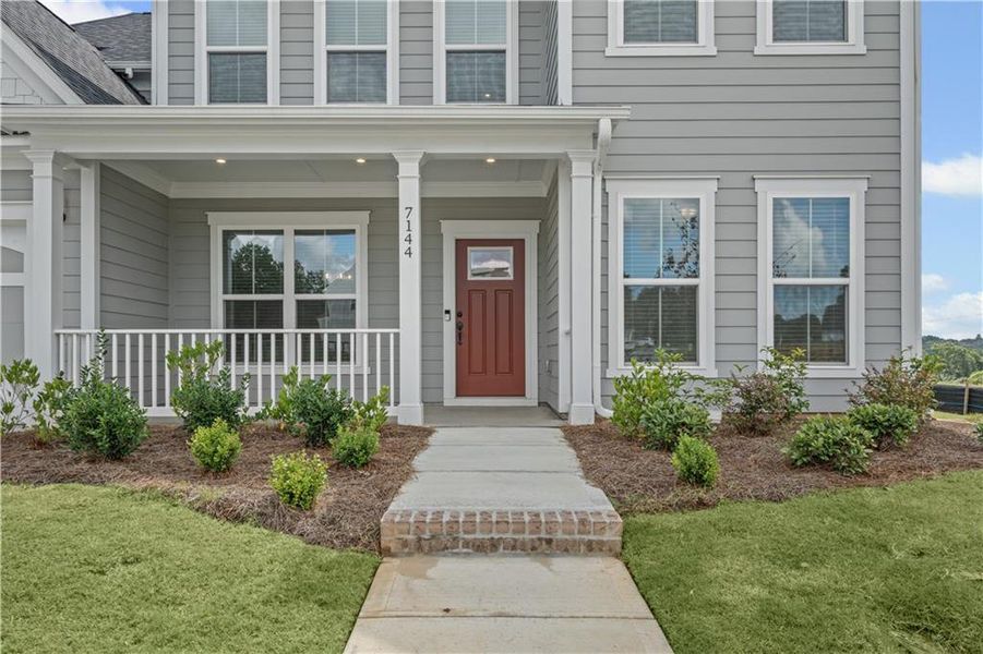 Front exterior of a new home in Reunion, Flowery Branch, GA, highlighting curb appeal (Image 21). Front exterior of a new home in Reunion, Flowery Branch, GA, highlighting curb appeal (Image 21).