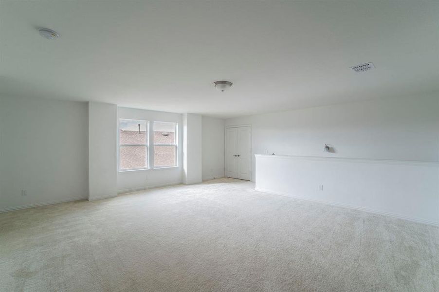 Spare room with carpet flooring and baseboards Spare room with carpet flooring and baseboards