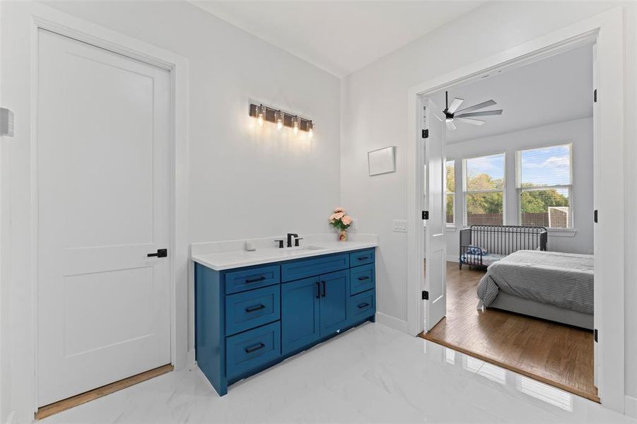 Bathroom with vanity, a ceiling fan, and light marble finish flooring Bathroom with vanity, a ceiling fan, and light marble finish flooring