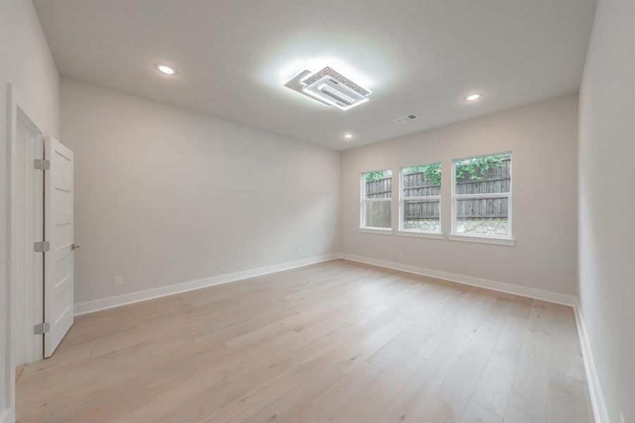 Spare room featuring light wood-style flooring and recessed lighting