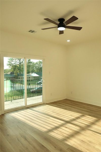 Upstairs, the primary bedroom offers a ceiling fan, a private balcony, and a spacious ensuite bathroom. Upstairs, the primary bedroom offers a ceiling fan, a private balcony, and a spacious ensuite bathroom.