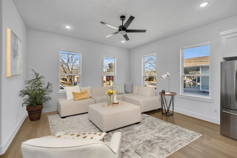 Living room featuring hardwood / wood-style flooring and ceiling fan