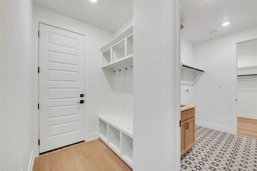 Mudroom featuring visible vents, recessed lighting, baseboards, and light wood-style floors Mudroom featuring visible vents, recessed lighting, baseboards, and light wood-style floors