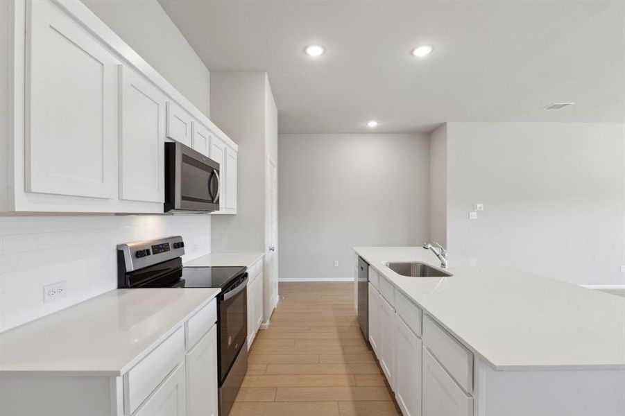 Kitchen in the Diamond home plan by Trophy Signature Homes – REPRESENTATIVE PHOTO