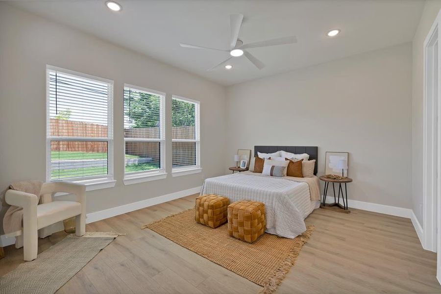 Bedroom with baseboards, light wood finished floors, recessed lighting, and ceiling fan Bedroom with baseboards, light wood finished floors, recessed lighting, and ceiling fan