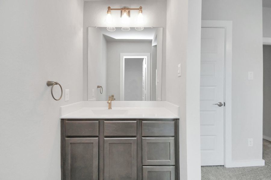 Elevating daily routines with a touch of sophistication – the sleek and functional vanity area in our Jack and Jill bedroom arrangement. Sample photo of completed home with similar floor plan. Actual colors and selections may vary. Elevating daily routines with a touch of sophistication – the sleek and functional vanity area in our Jack and Jill bedroom arrangement. Sample photo of completed home with similar floor plan. Actual colors and selections may vary.