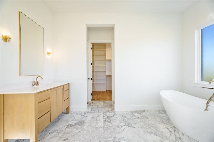 Bathroom featuring a bathing tub and vanity