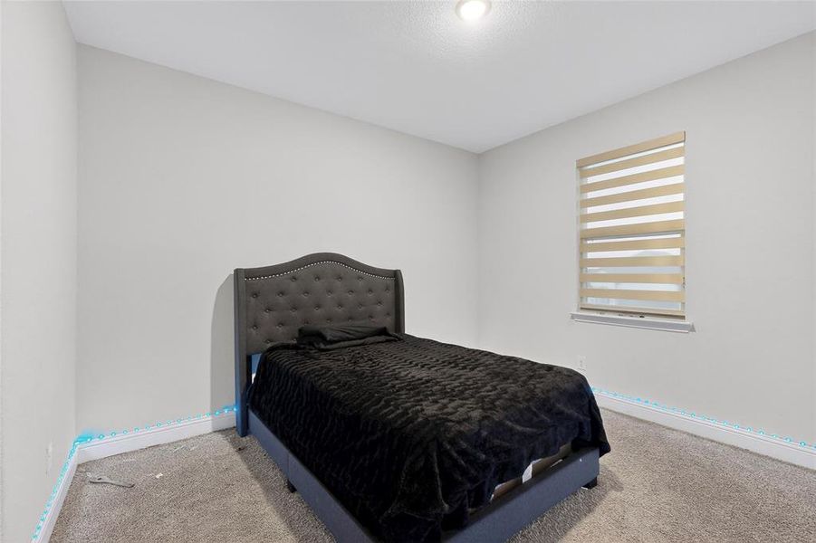 Carpeted bedroom with baseboards