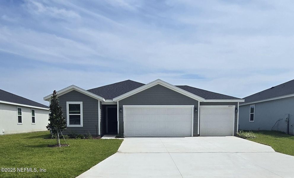 Front exterior of a new home in Azalea Creek, Jacksonville, FL, highlighting curb appeal (Image 21).