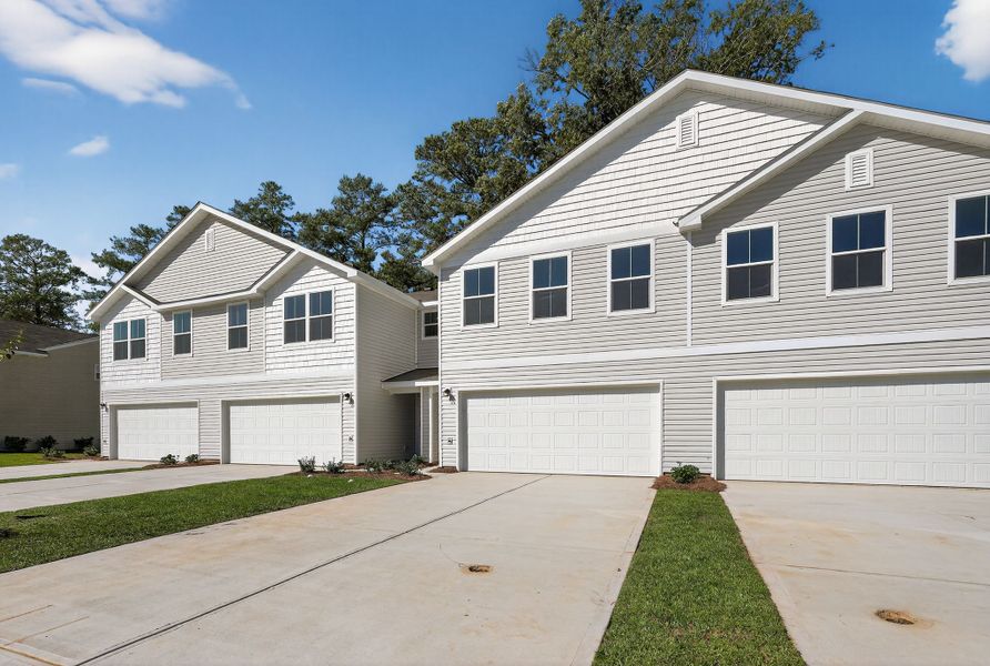 A white house with garages.