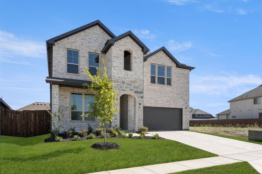 Front exterior of a new home in The Oaks, Red Oak, TX, highlighting curb appeal (Image 2). Front exterior of a new home in The Oaks, Red Oak, TX, highlighting curb appeal (Image 2).