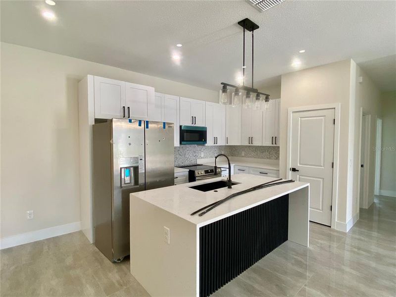 kitchen with island, quartz counter tops, blak farm house sink
