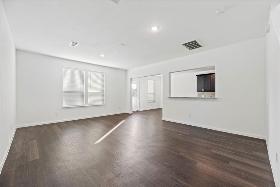 Family room offers vinyl plank flooring and backyard views. Family room offers vinyl plank flooring and backyard views.