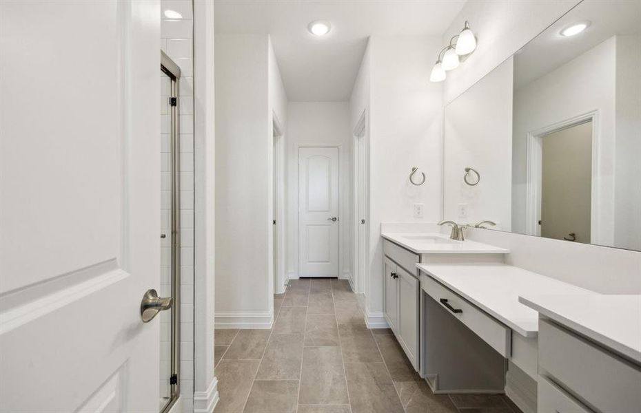 Elegant owner's bathroom with dual vanity *real home pictured