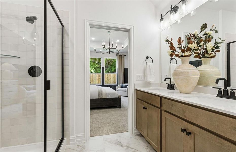 Owner's private bath with tile-surround shower and double vanity*model representation