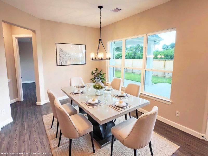 Indulge in elegance where the dining area seamlessly lends sophistication and comfort. With ample space, stunning finishes, and a warm ambiance, it provides intimate dinners and festive gatherings. Image depicts home as-is virtually staged.