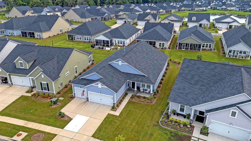 Front exterior of a new home in Horizons at Summers Corner | 55+: The Estates, Summerville, SC, highlighting curb appeal (Image 34).