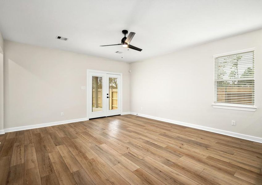 The spacious family room has double doors that lead to the back patio