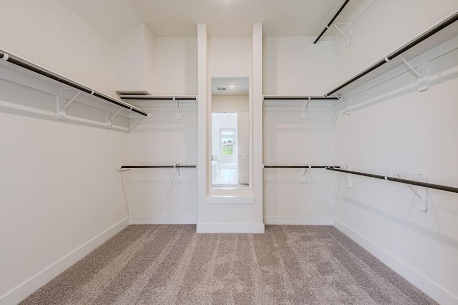 The walk-in closet offers generous storage with ample room for clothing, shoes, and accessories The walk-in closet offers generous storage with ample room for clothing, shoes, and accessories