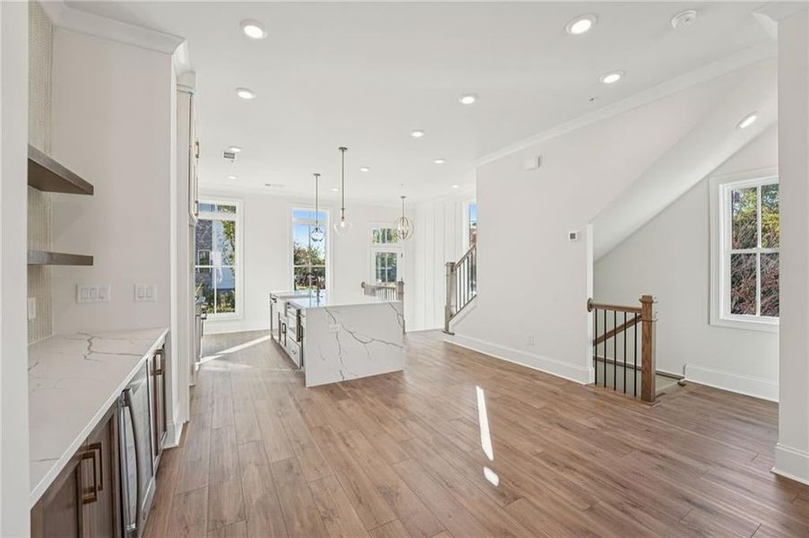 Dining space with beverage center:  upgraded flooring, cabinets, quartz tops, floating shelves allows for you to entertain.  Image is of a previously built Chamberlain. Image of previously built Chamberlain plan.