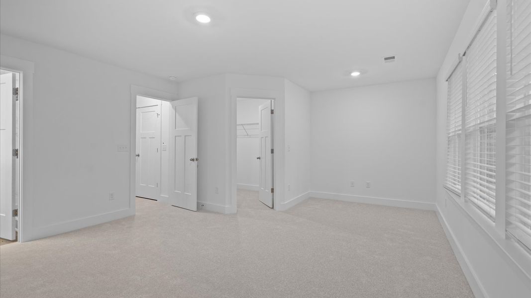 Eye-catching details and elegant finishes in the vibrant primary suite of this select home Eye-catching details and elegant finishes in the vibrant primary suite of this select home