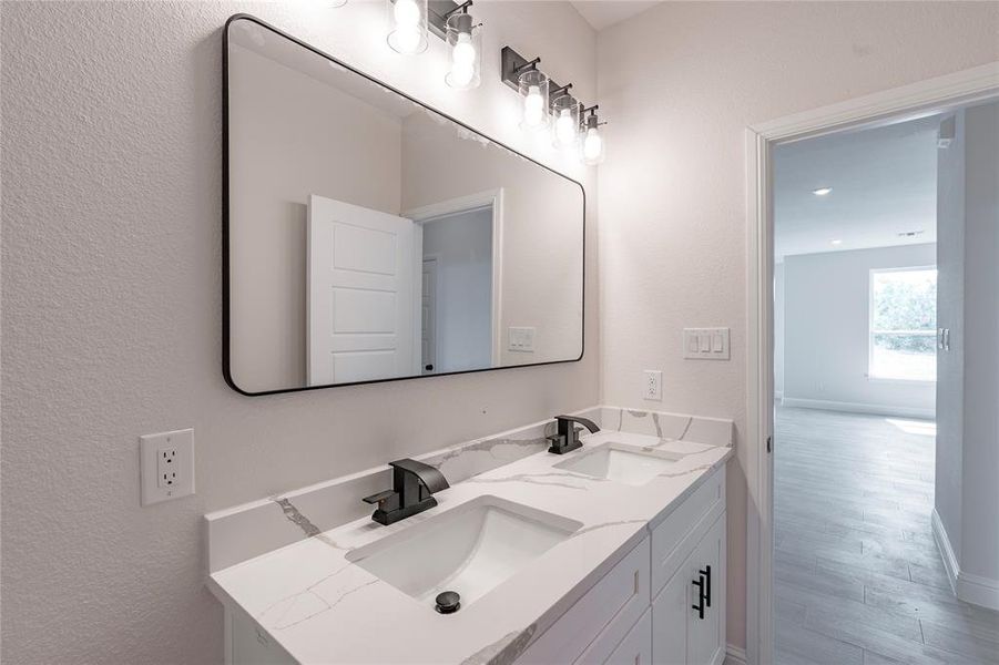 Bathroom with double sink vanity and hardwood / wood-style flooring