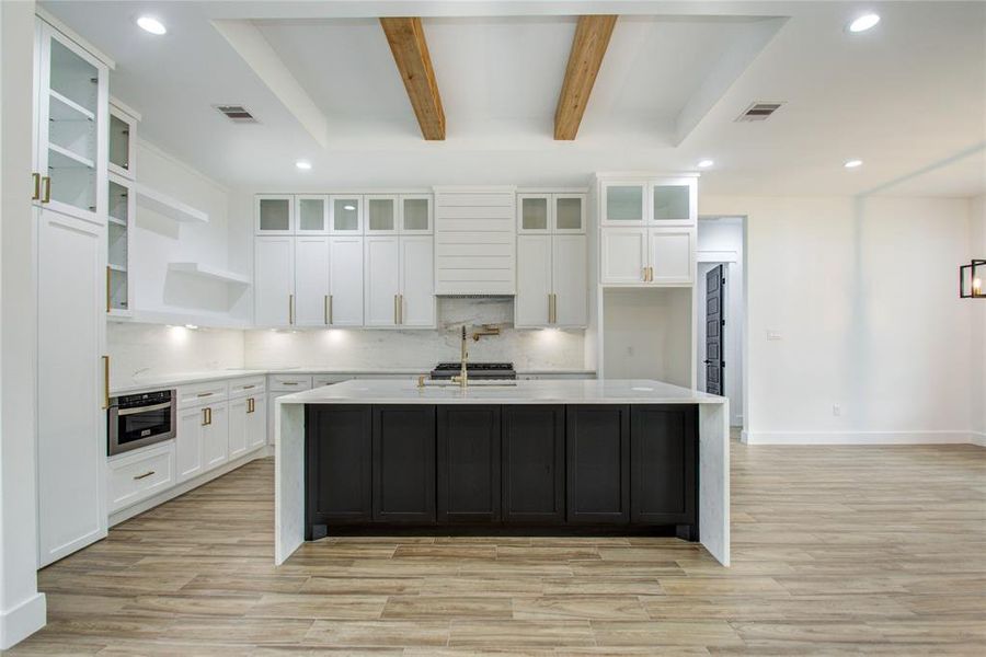 Kitchen Features: Custom cabinetry, waterfall island, pot-filler, ZLine luxury appliances, hidden walk in pantry, tray ceilings, and so much more.