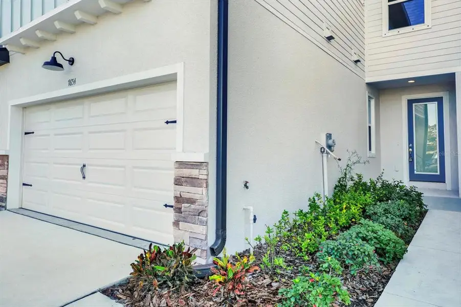 Exterior details and patio area of a home in The Towns At Long Bayou, Seminole (Image 4).